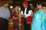 Governor and First lady lighting the inaugural lamp of the musical programme, while Singer Niharika Naidu looks on : Itanagar: 23/05//2010