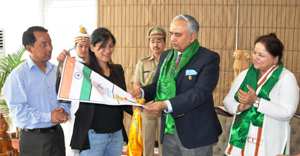 The Governor of Arunachal Pradesh Lt. Gen (Retd) Nirbhay Sharma handing over the flagged Ice Axe to Smt Anshu Jamsenpa who is attempting a double ascent of Mt Everest, at Raj Bhawan, Itanagar on 3rd April 2014. Also seen: The First Lady of the State, Smt Jyotsna Sharma and Smti Anshu Jamsenpa�s husband and the President of Arunachal Mountaineering & Adventure Sports Association, Shri Tsering Wange