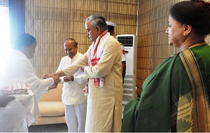 A member of Brahma Kumari tying �Rakhi� to the Governor of Arunachal Pradesh Lt. Gen (Retd) Nirbhay Sharma on the occasion of Raksha Bandhan at Raj Bhawan, Itanagar on 10th August 2014: Also seen in the right: First Lady of the State Smt Jyotsna Sharma.