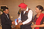 Everester Tapi Mra presenting his summit photograph to the Governor